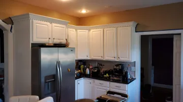 Craftsman building custom kitchen cabinets in workshop