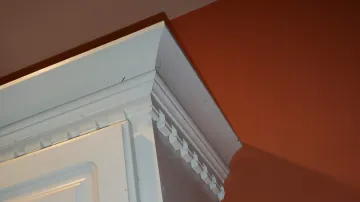 Cabinet contractor measuring and installing custom kitchen cabinets during a remodel