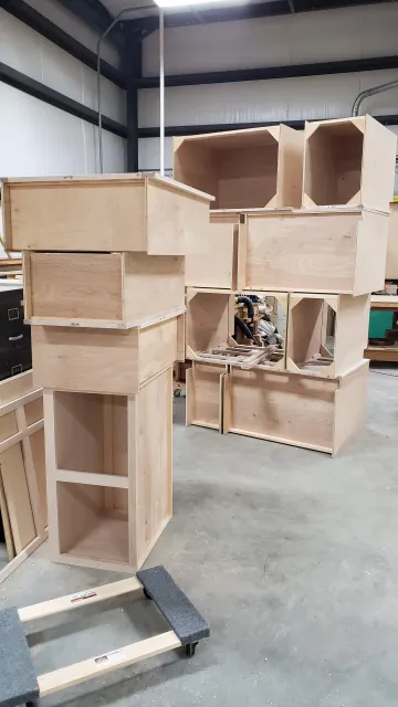 Cabinet maker measuring and installing custom built-in cabinets