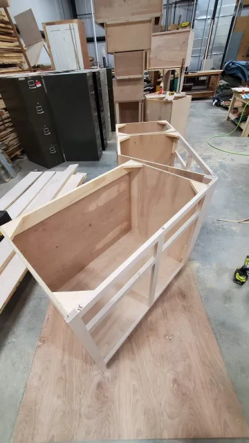 Craftsman building custom 24 inch bathroom vanity with precision tools