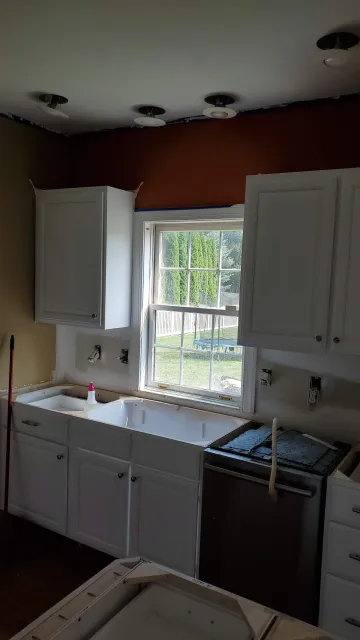 Custom wood and painted kitchen cabinets installed in a modern home