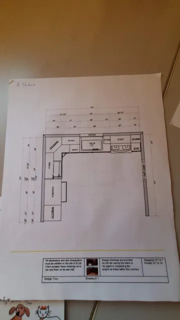 Cabinet maker measuring and installing a corner wall mount kitchen cabinet
