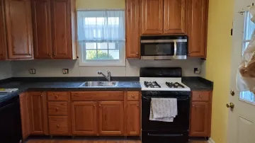 Cabinet maker measuring and installing a custom entertainment built-in unit
