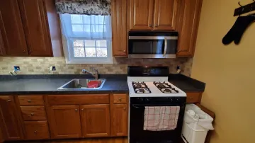 Cabinet maker measuring and planning kitchen layout in a new construction home