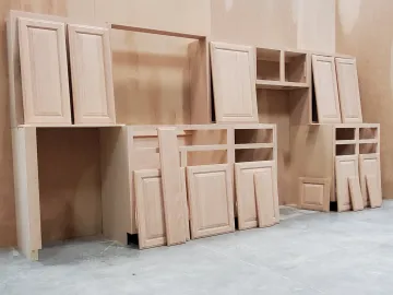 Cabinet maker measuring and installing custom kitchen cabinets