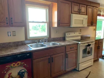 Cabinet maker measuring and installing custom cabinets in a home kitchen
