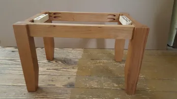 Cabinet maker measuring and installing a wall mounted bathroom cabinet