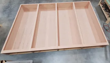Cabinet installer measuring and mounting custom bathroom cabinets