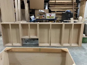 Craftsman building custom bathroom vanity in workshop