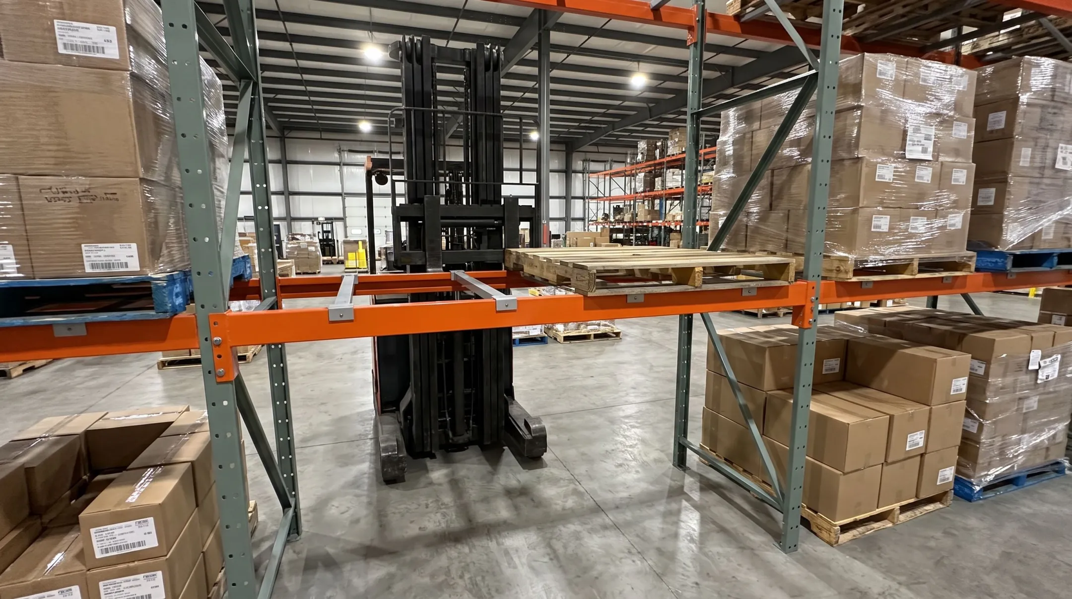 Heavy-duty structural steel pallet racking in industrial warehouse setting