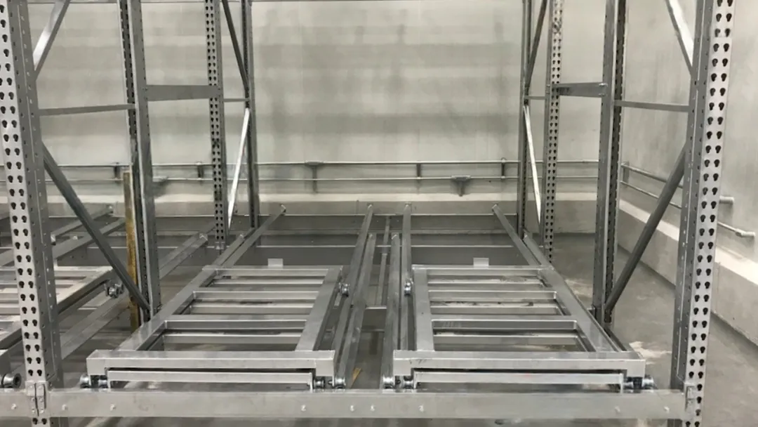 RackUSA Matador automated pallet shuttle system inside rack channel