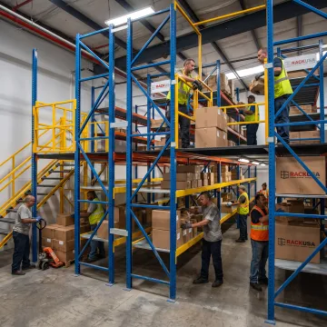 Warehouse team working beside a steel mezzanine
