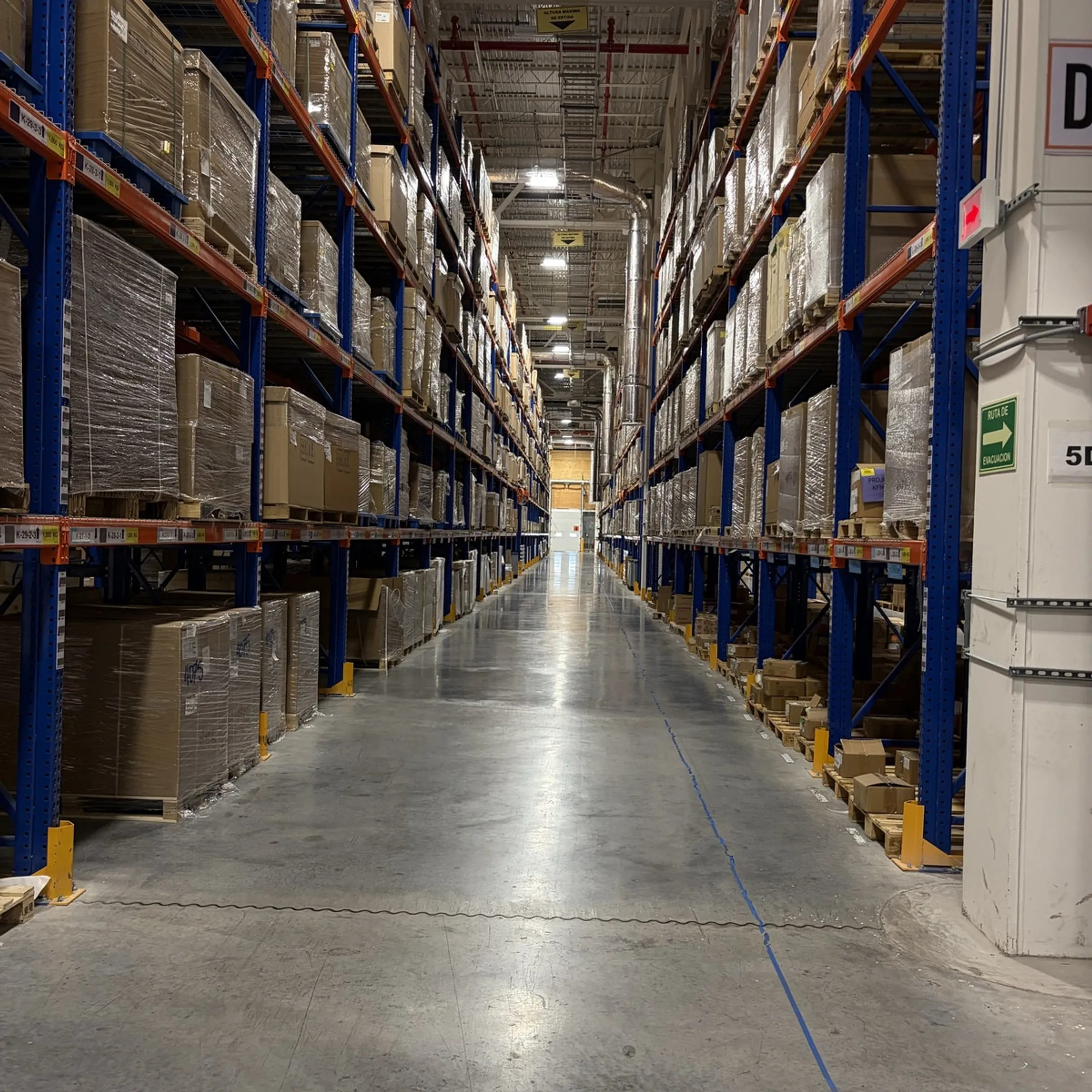 Warehouse manager reviewing pallet rack layout