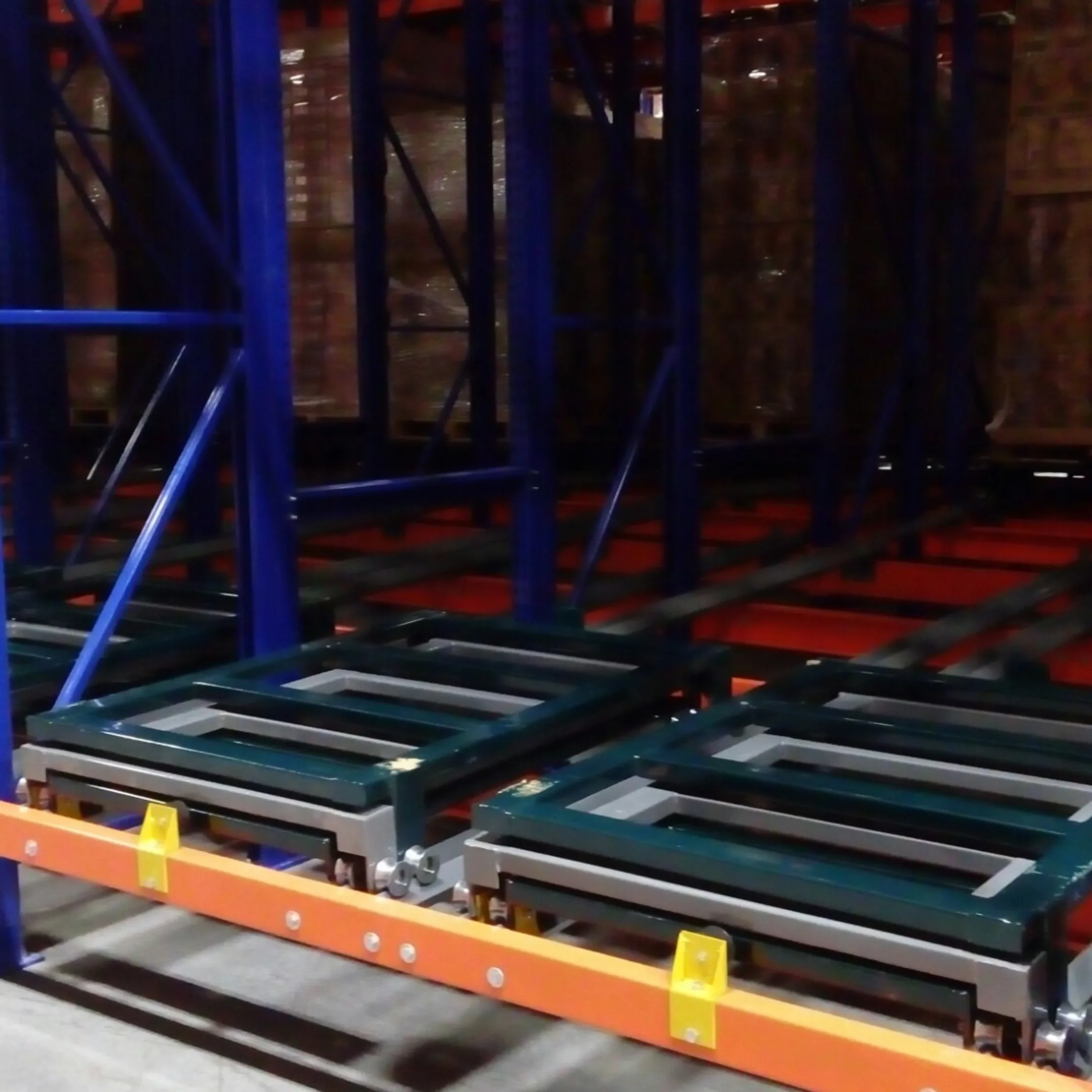 Forklift loading pallets into pushback racking