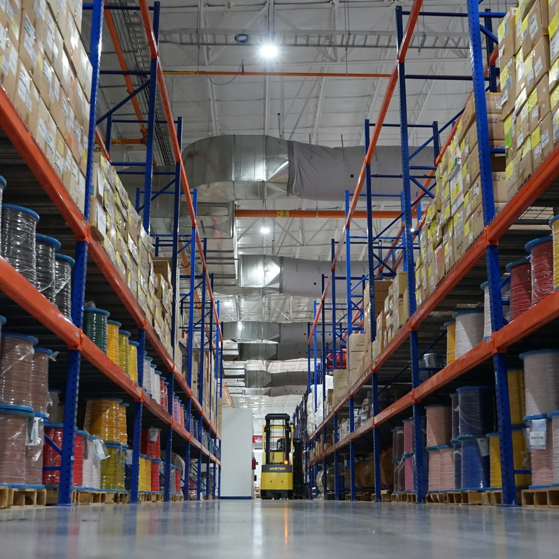 Warehouse worker reviewing organized pallet racking
