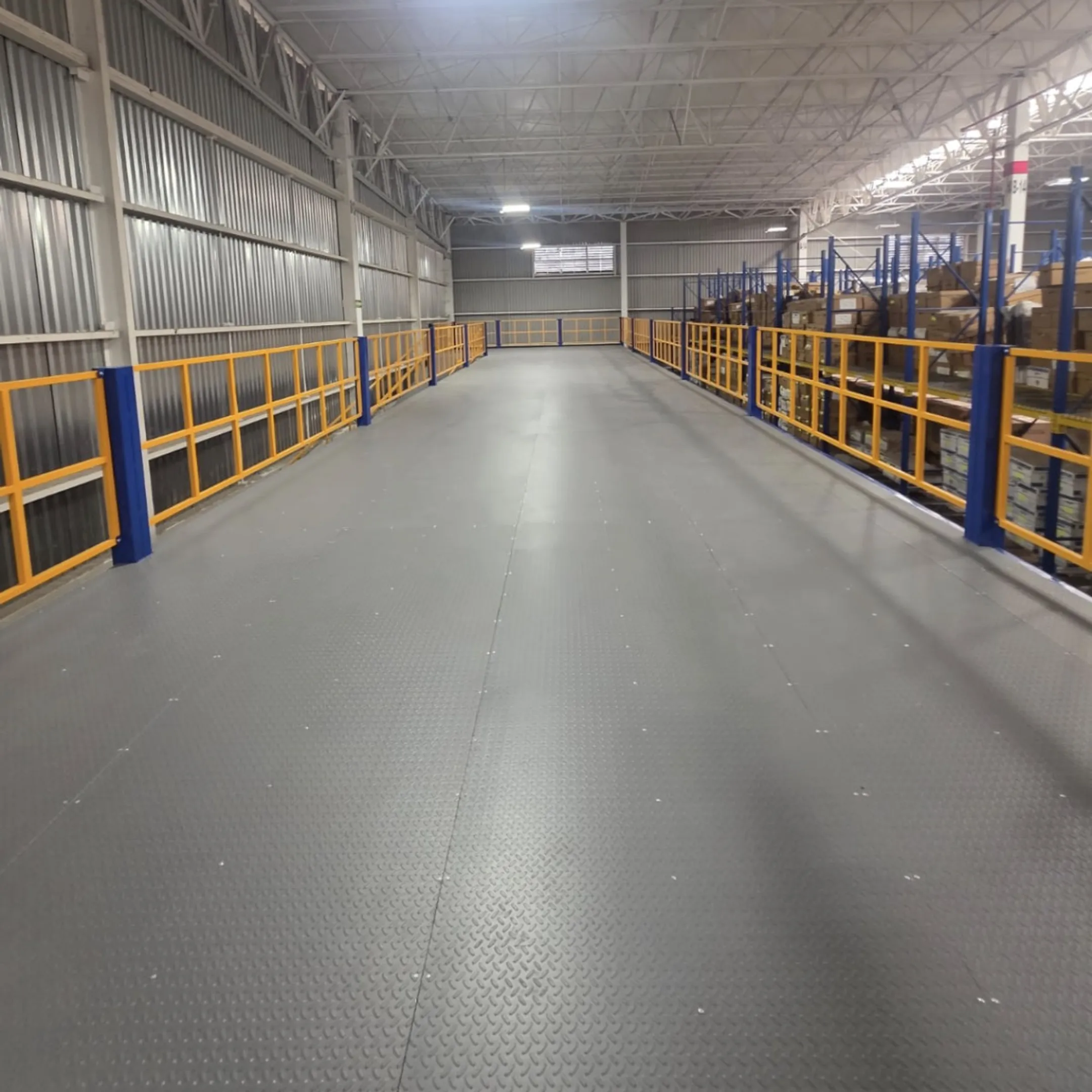 Warehouse team working beside a steel mezzanine