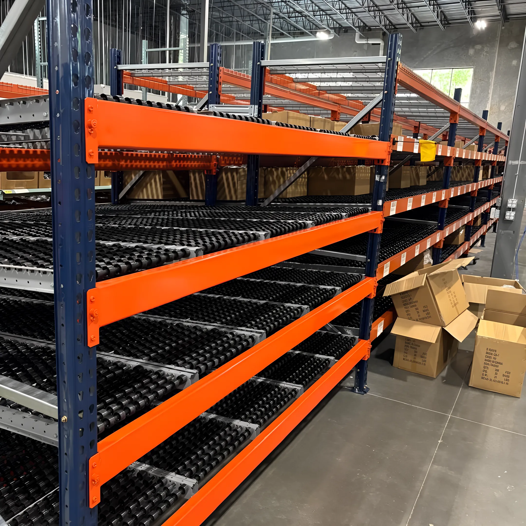 Warehouse team installing carton flow rack lanes