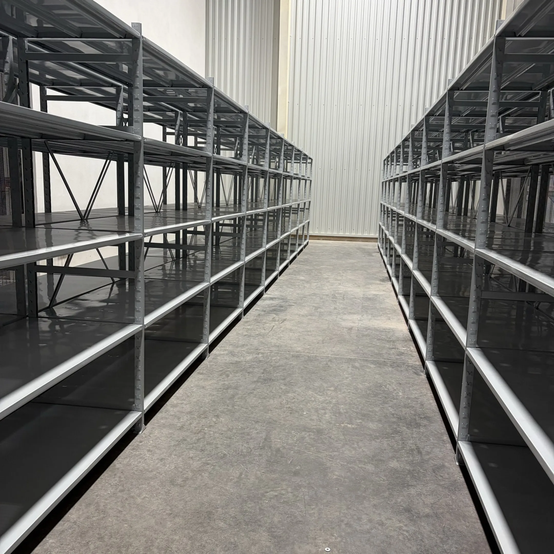 Warehouse manager reviewing industrial shelving layout