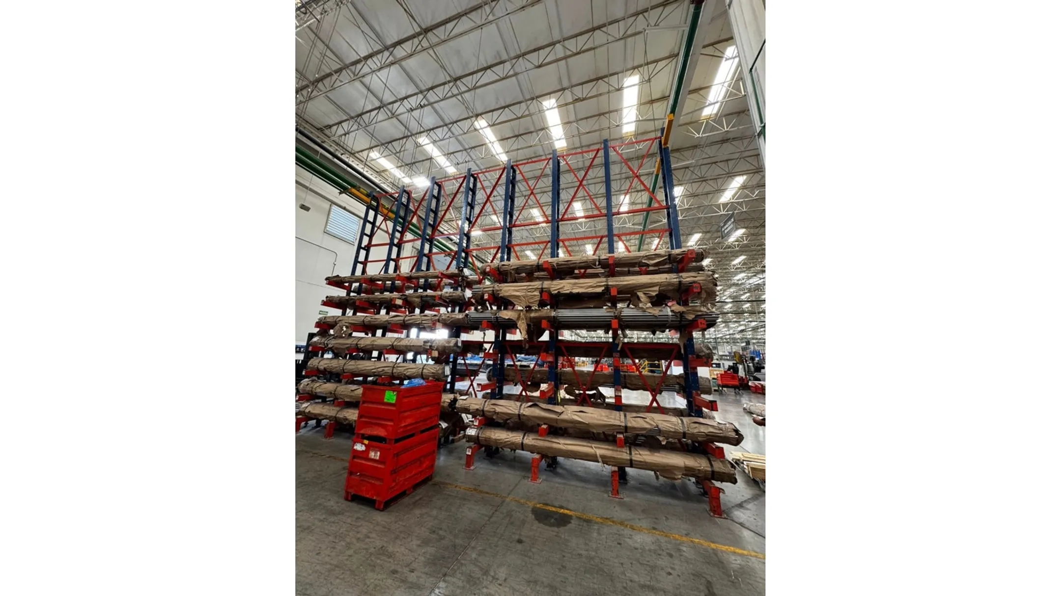 Forklift loading long lumber onto open-front cantilever storage racks