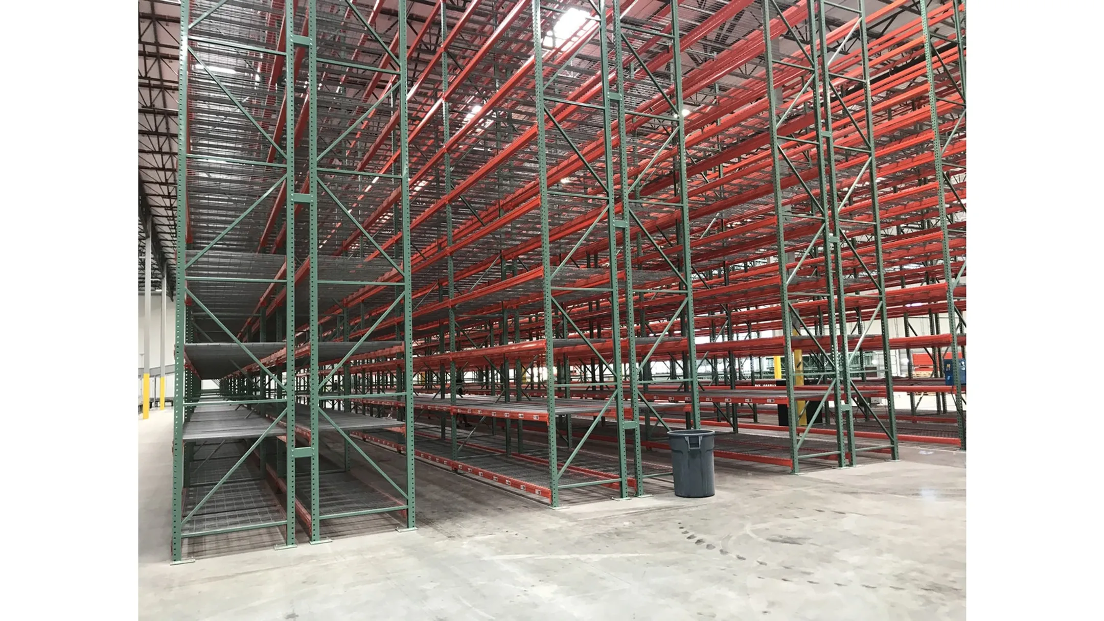 OSHA compliant warehouse racking with load capacity labels and clear aisles