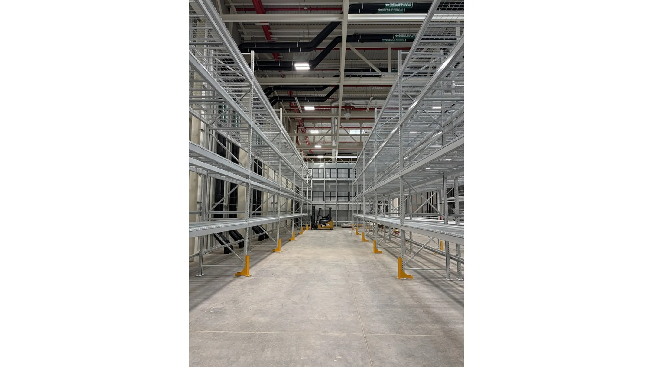 Large distribution center warehouse with very narrow aisle racking and turret trucks