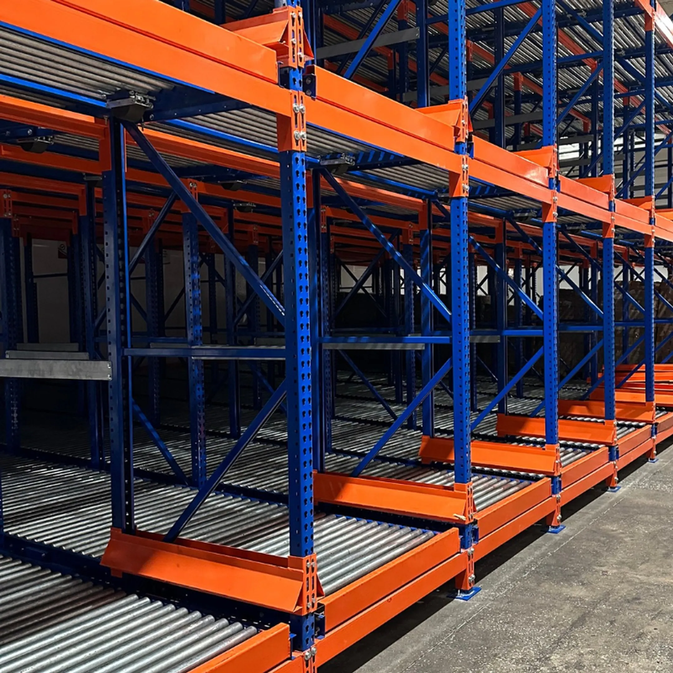 Technician inspecting pallet flow rack mounting brackets