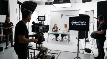 Professional video production team filming eLearning training module on studio set