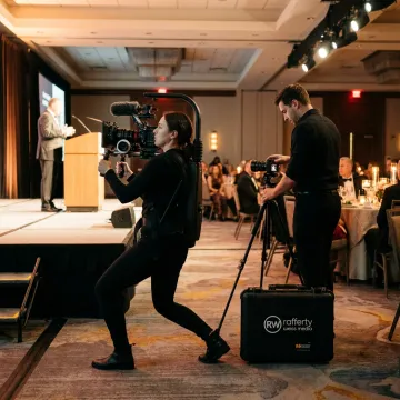 Camera crew filming a fundraising gala event