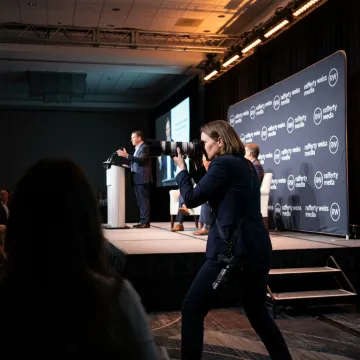 Corporate event photographer capturing a keynote presentation