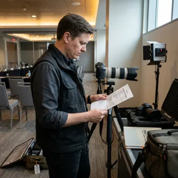 Corporate photographer reviewing event shot list