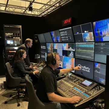 Broadcast video production crew supporting a professional filming setup