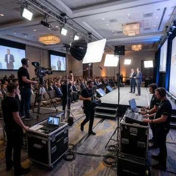 Professional video crew filming a live corporate event