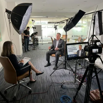 Corporate video production crew filming an executive interview