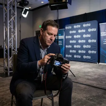 Photographer reviewing corporate event shots on camera
