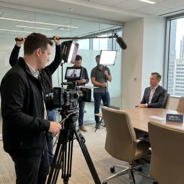 Video crew filming a business interview on location