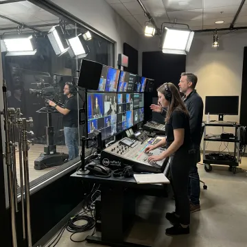 Professional broadcast video production crew filming on set