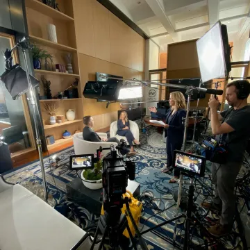Video crew directing an executive interview on set