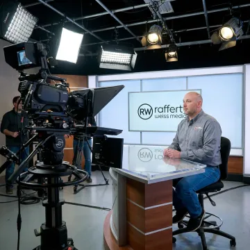Executive speaking on camera in a professional video production studio