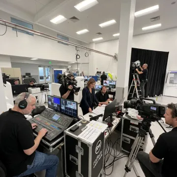 Event producer reviewing a show schedule with AV crew