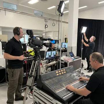 Professional event production team managing cameras and AV equipment