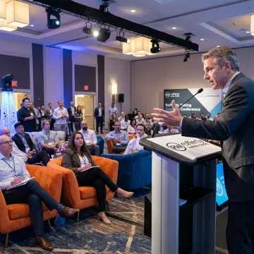 Corporate event photographer capturing a keynote speaker