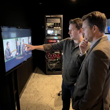 Producer reviewing video footage with a client