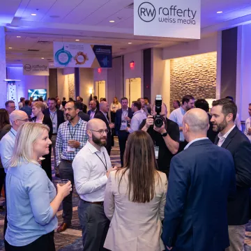 Corporate attendees networking at a branded event