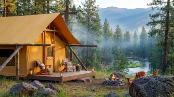 Luxury wilderness glamping tent overlooking vast Montana forest and river landscape