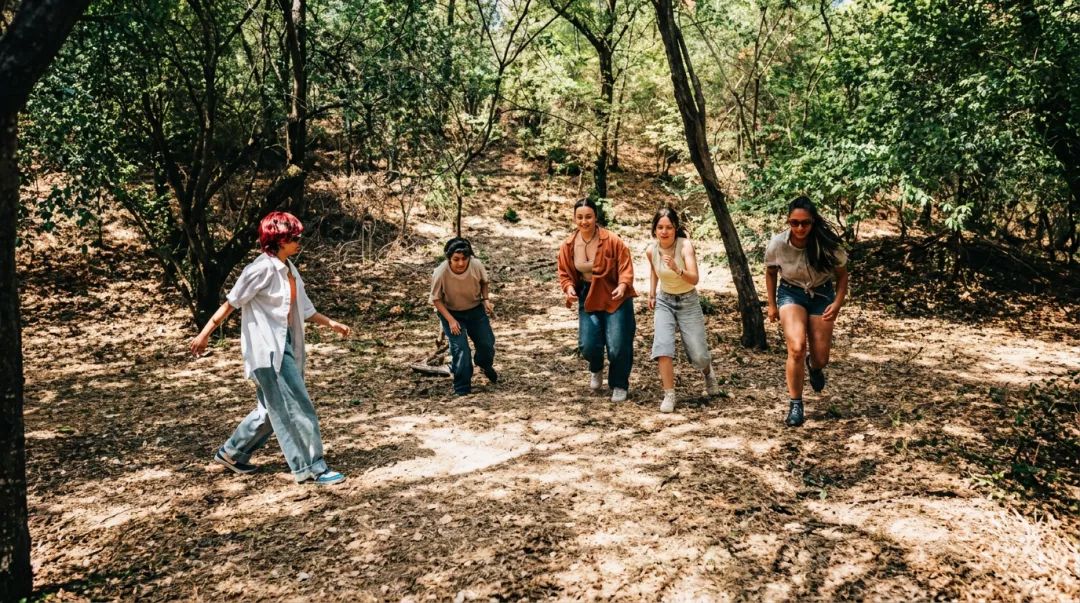 Corporate team hiking wooded trail together during reflective team-building retreat