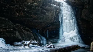 Frozen waterfall and ice formations inside Hocking Hills sandstone gorge in winter