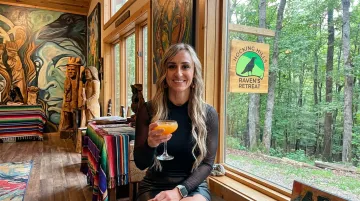 Raven's Retreat Hocking Hills art lodge interior with handcrafted sculptures and forest views