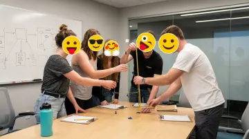 Small team collaborating on marshmallow challenge spaghetti tower building exercise
