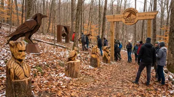 Raven's Retreat Hocking Hills forested trails with art installations for outdoor activities