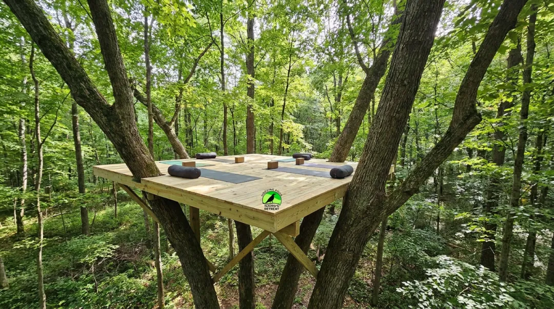 Elevated wooden yoga platform set into forest canopy at Raven's Retreat Hocking Hills